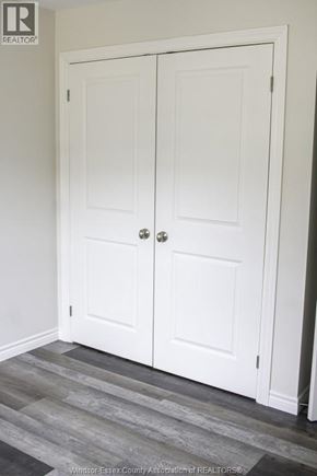 Windsor townhouse for rent - A white double door with a silver handle is in a room with a wooden floor.