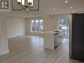 Woodstock (Woodstock - North) house for rent - A spacious kitchen with a refrigerator, sink, and cabinets.