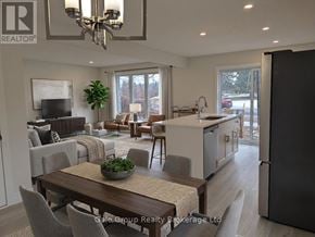 Woodstock (Woodstock - North) house for rent - A modern kitchen and dining area with a large island and a view of the backyard.