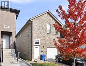 Windsor house for rent - A tree with red leaves is in front of a house with a car parked in front of it.