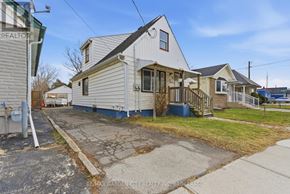 St. Catharines (Western Hill) duplex for rent - A white house with a grey roof is for sale.