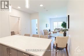 Ottawa condo for rent - A realtor's office with a desk and chairs.