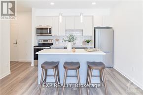 Ottawa condo for rent - A kitchen with a white countertop and bar stools.