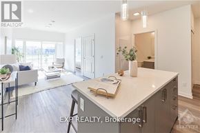 Ottawa condo for rent - A modern kitchen with a large island and a dining area with a table and chairs.