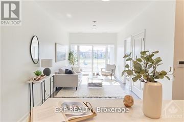 Ottawa condo for rent - A living room with a grey couch and a white vase on the table.