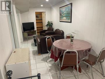 Toronto (L'amoreaux) house for rent - A living room with a television, couches, and a painting on the wall.