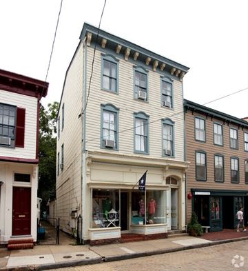 Annapolis apartment for rent - A white building with a red door and a black flag on the front.