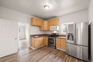 Richmond apartment for rent - A kitchen with wooden cabinets and stainless steel appliances.