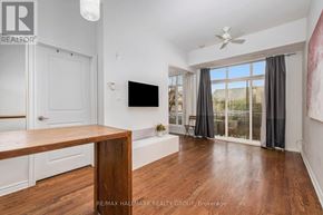 Ottawa condo for rent - A living room with a flat screen TV mounted on the wall.