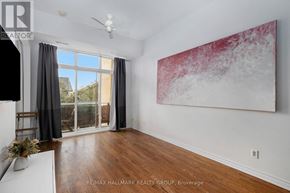 Ottawa condo for rent - A room with a large painting on the wall and a ceiling fan.