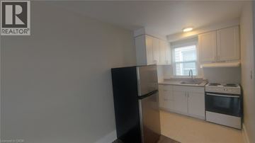 Kitchener apartment for rent - A kitchen with white cabinets and appliances.