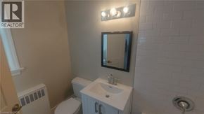 Kitchener apartment for rent - A bathroom with a white sink and a mirror above it.