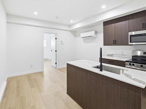 Swan River apartment for rent - A white oven in a bathroom with a toilet and a black door.