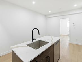 Swan River apartment for rent - A white toilet sits next to a glass shower stall.