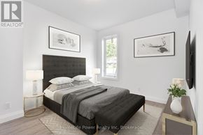 For rent in North Dumfries - A bedroom with a large bed and a flat screen TV mounted on the wall.