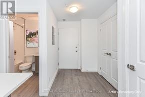 For rent in North Dumfries - A white bathroom with a toilet, sink, and a door.