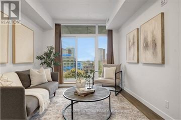 Ottawa condo for rent - A living room with a grey couch, a coffee table, and two paintings on the wall.