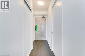 Burlington condo for rent - A hallway with a door covered in plastic wrap.