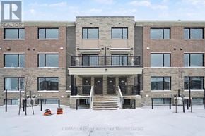 Ottawa townhouse for rent - A large building with a balcony in the middle of it.