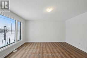 Ottawa townhouse for rent - A room with a window overlooking a snowy landscape.