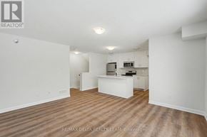 Ottawa townhouse for rent - A large empty room with wooden floors and white walls.
