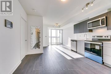 Burlington (Alton) condo for rent - A modern kitchen with white cabinets and a wooden floor.