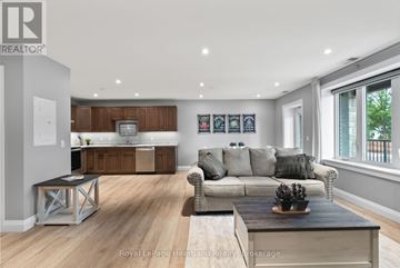 North Huron (Wingham) multi-family for rent - A modern living room with a grey couch and a wooden coffee table.
