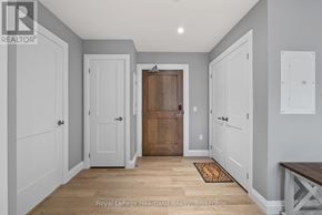 North Huron (Wingham) multi-family for rent - A hallway with a wooden floor and white walls.