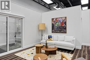 Lasalle apartment for rent - A living room with a white couch, a coffee table, and a painting on the wall.