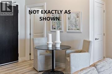 Lasalle apartment for rent - A living room with a wooden chair, a brown coffee table, and a painting on the wall.