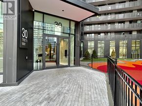 Toronto (Clanton Park) condo for rent - The entrance to a building with a sign that reads "30 Tretti Way".