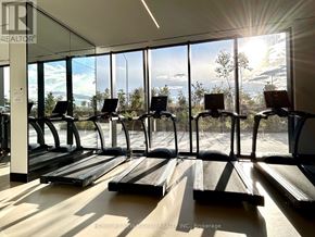 Toronto (Clanton Park) condo for rent - A gym with treadmills and a view of the sky through the windows.