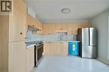 Waterloo townhouse for rent - A kitchen with wooden cabinets and a blue fridge.
