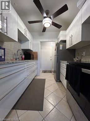 Hamilton apartment for rent - A kitchen with a ceiling fan and a black mat on the floor.
