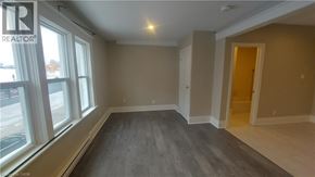 Kitchener apartment for rent - A room with a window and a door is available for rent.