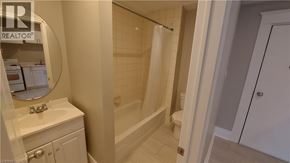 Kitchener apartment for rent - A bathroom with a white sink and a white toilet.