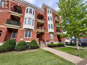 London East (East F) condo for rent - A red brick building with a balcony on the second floor.