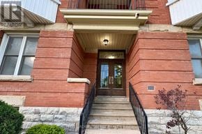 London East (East F) condo for rent - A red brick building with a black railing on the steps.