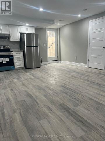 Brampton (Credit Valley) house for rent - A spacious kitchen with a refrigerator and a countertop.