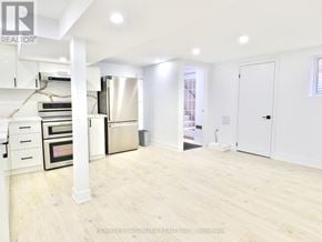Whitby (Pringle Creek) house for rent - A spacious kitchen with white cabinets and a stainless steel refrigerator.