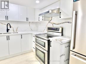 Whitby (Pringle Creek) house for rent - A kitchen with white cabinets and appliances, including a refrigerator, oven, and microwave.