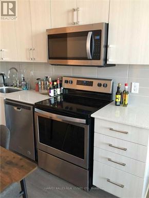 Toronto (Bayview Village) condo for rent - A modern kitchen with a stainless steel oven and microwave.