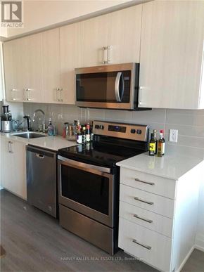 Toronto (Bayview Village) condo for rent - A modern kitchen with a stainless steel oven and microwave above it.