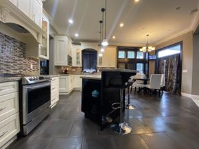 Surrey house for rent - A modern kitchen with a black countertop and stove.