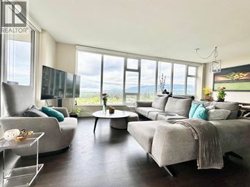 Vancouver apartment for rent - A living room with a grey couch and a glass table.