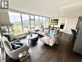 Vancouver apartment for rent - A living room with a grey couch and a coffee table.
