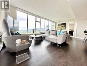 Vancouver apartment for rent - A living room with a grey sofa, a grey armchair, and a coffee table.