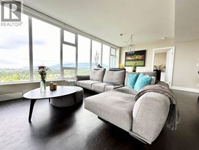 Vancouver apartment for rent - A living room with a grey couch and a coffee table.