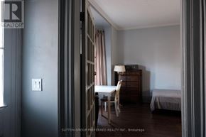 London East (East B) house for rent - A room with a bed, a chair, and a dresser.