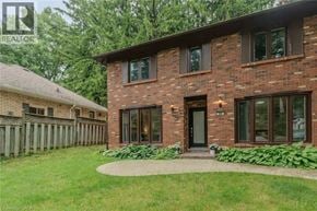 Ancaster house for rent - A house with a brown brick exterior and a black front door.